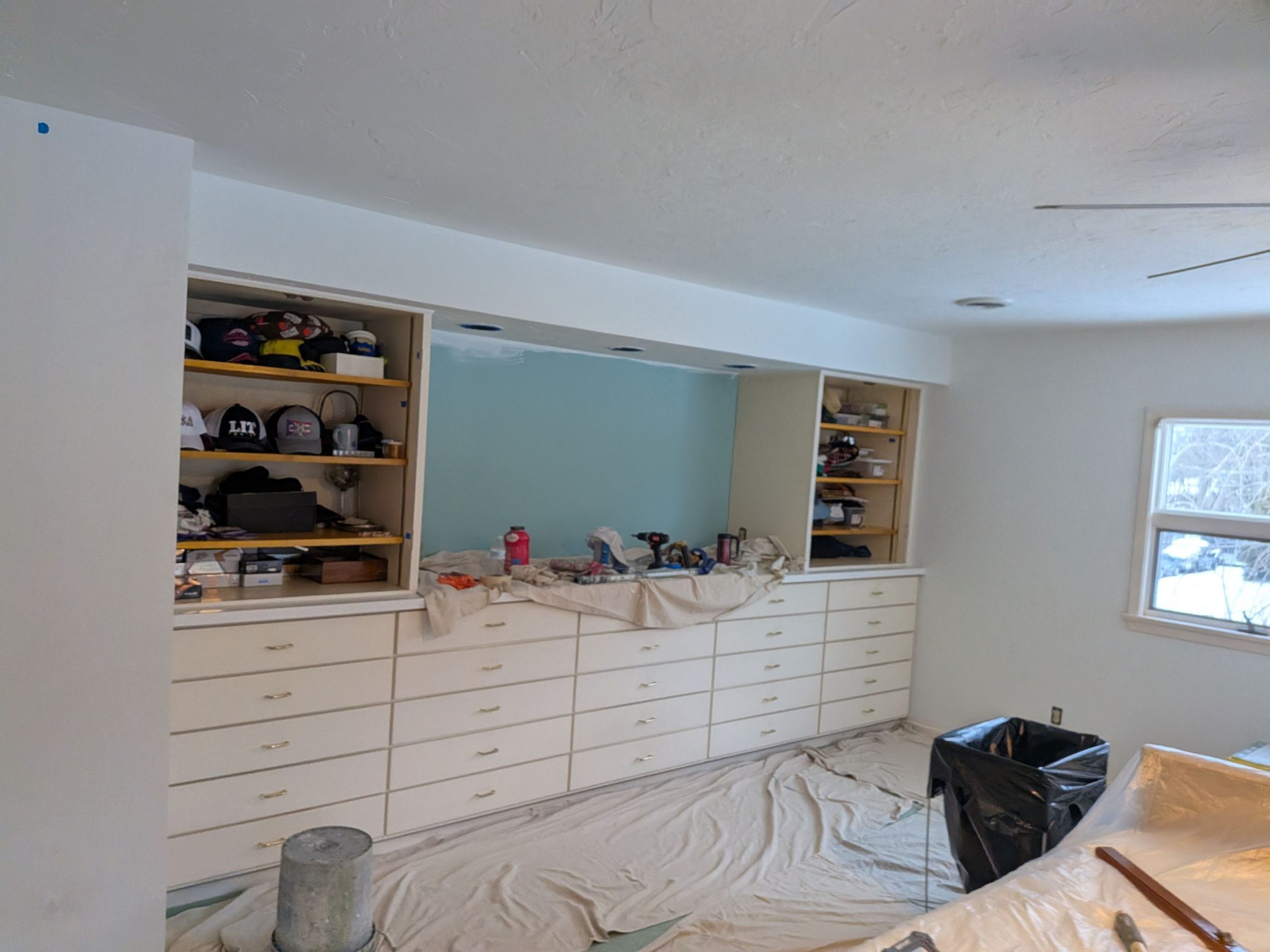 Interior painting Westlake OH — bedroom built-in cabinets before painting, yellowed finish